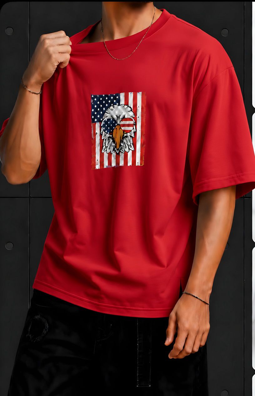 American Eagle Graphic Oversized T-Shirt – Red Red oversized T-shirt featuring a bold American eagle and flag graphic on the front, paired with black pants.