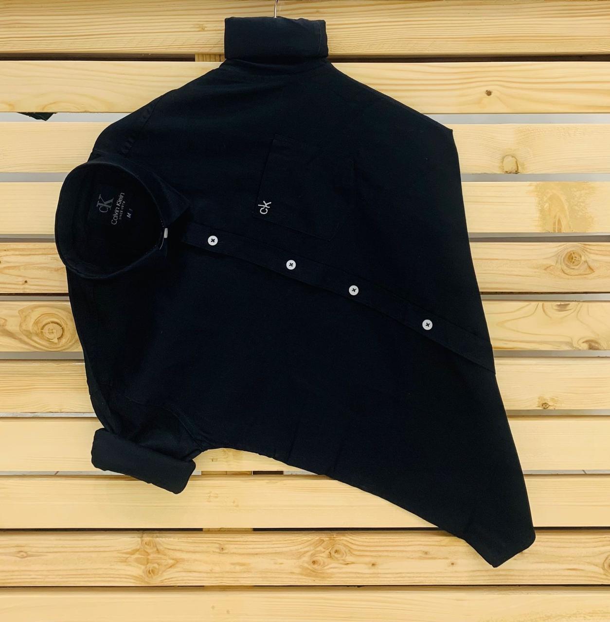 Calvin Kevin Plain Shirt – Black Calvin Kevin black plain men's shirt with hard collar, full sleeves and embroidered logo.