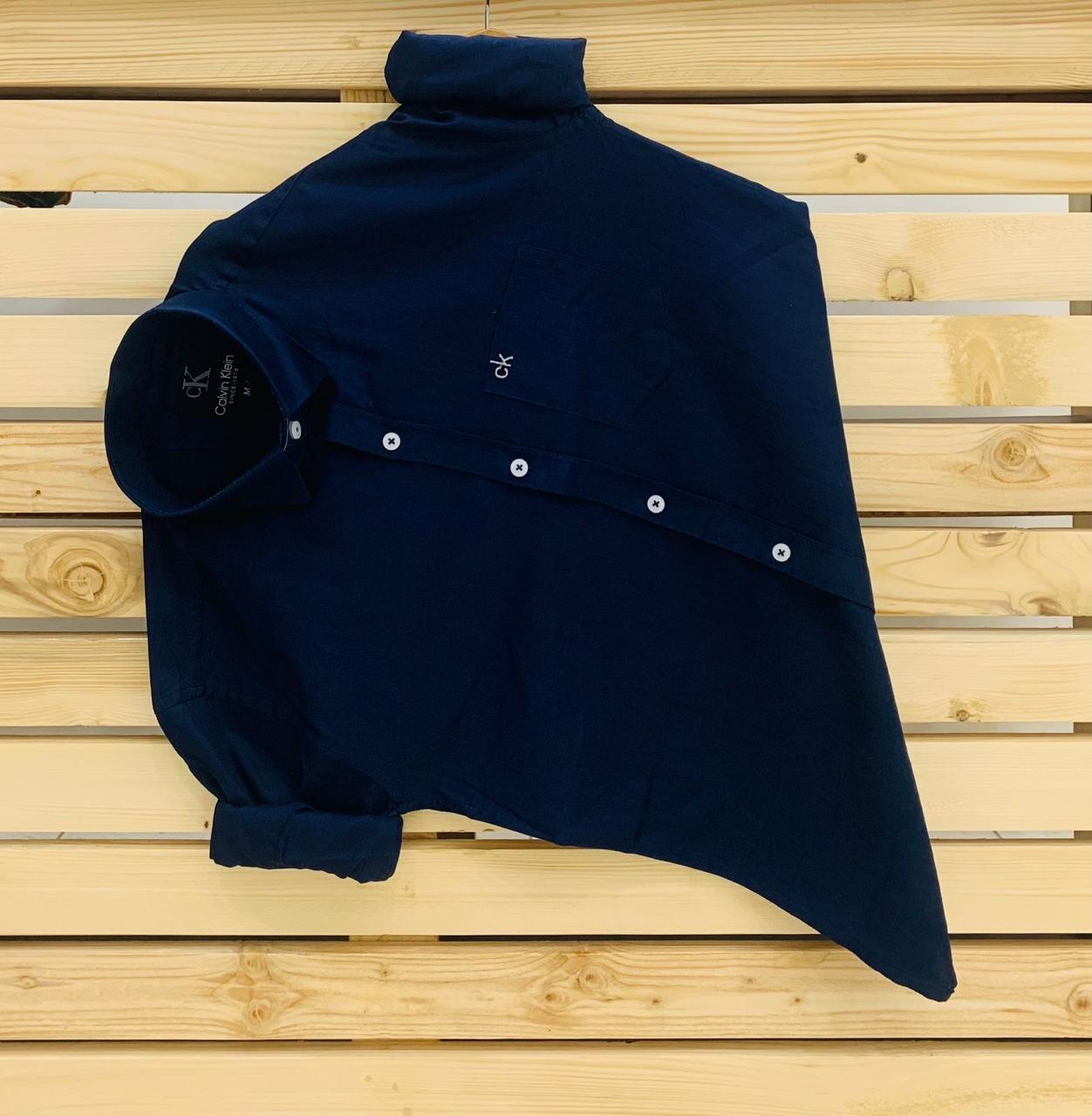 Calvin Kevin Plain Shirt – Navy Blue Calvin Kevin navy blue plain men's shirt with hard collar, full sleeves and embroidered logo.