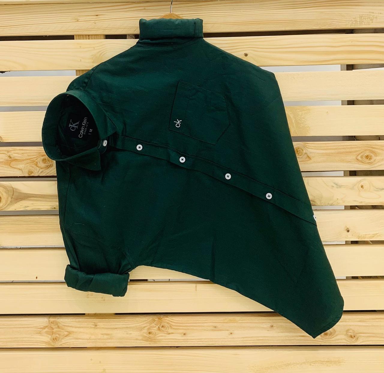 Calvin Kevin Plain Shirt – Dark Green Calvin Kevin dark green plain men's shirt with hard collar, full sleeves and embroidered logo.