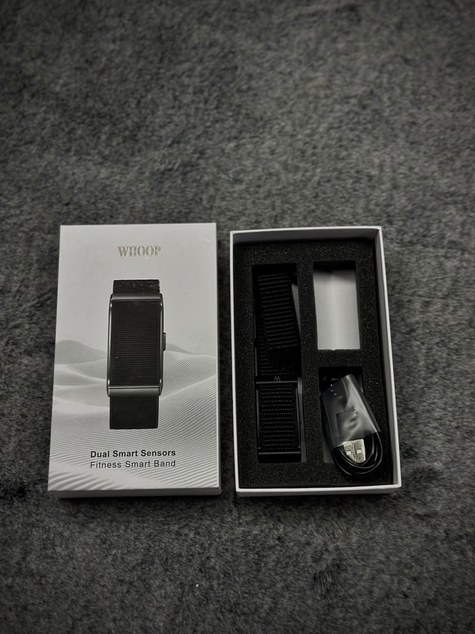 WHOOP Dual Smart Sensors Fitness Smart Band – Black WHOOP Dual Smart Sensors Fitness Smart Band in black with adjustable fabric strap and USB charging cable